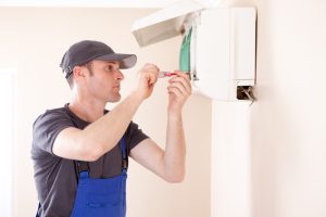 HVAC-technician-repairing-a-ductless-mini-split-air-handler